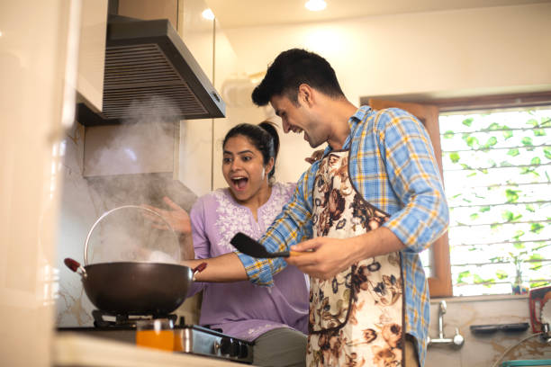 istock Cheerful young couple cooking together in kitchen 1691791118