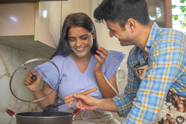 istock Cheerful young couple cooking together in kitchen 1691791888
