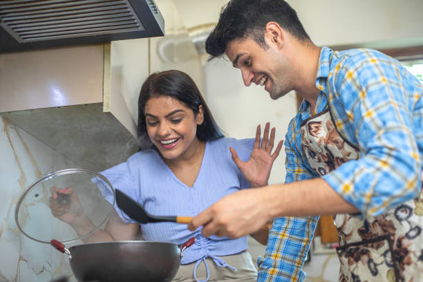 istock Cheerful young couple cooking together in kitchen 1691792757