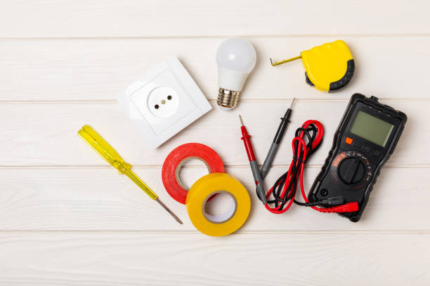 istock Electrician equipment on  background with copy space.Top view.Electrician tool set.Multimeter, tester,screwdrivers,cutters,duct tape,lamps,tape measure and wires.Flet lay. 1691797204