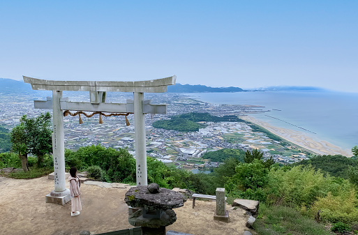 Kagawa, Japan - May 20, 2023: Panoramic view of Kannonji city and Seto inland sea, and Tenku no Torii (Torii in the sky) of Takaya Shrine on the top of Mt Inazumi