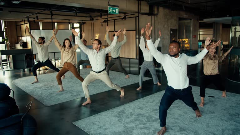 The international team does yoga during the break between work in the office. Oyise workers keep their body and mind in fine