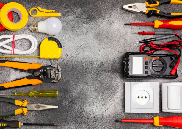 istock Electrician equipment on  background with copy space.Top view.Electrician tool set.Multimeter, tester,screwdrivers,cutters,duct tape,lamps,tape measure and wires.Flet lay. 1691802908