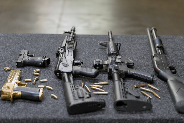 istock Rifles and pistols with cartridges on the table in a shooting range 1691808450