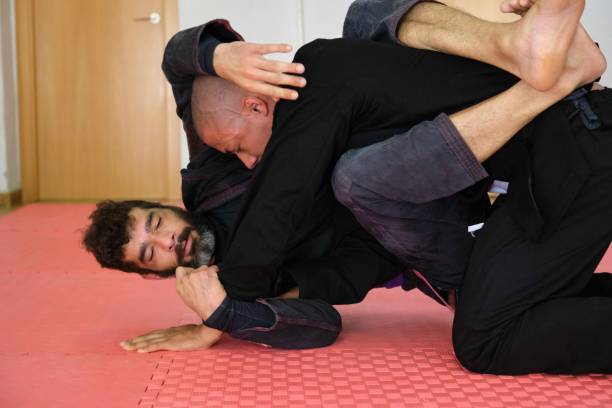 istock Two men practicing Brazilian Jiu-Jitsu wrestling at the School. 1691812350
