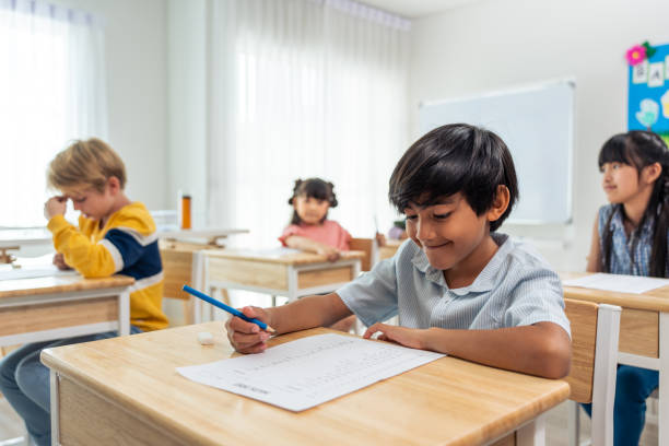 istock Group of student learn with teacher in classroom at elementary school. Attractive beautiful female instructor master explain and educate young children with happiness and fun activity at kindergarten. 1691814068