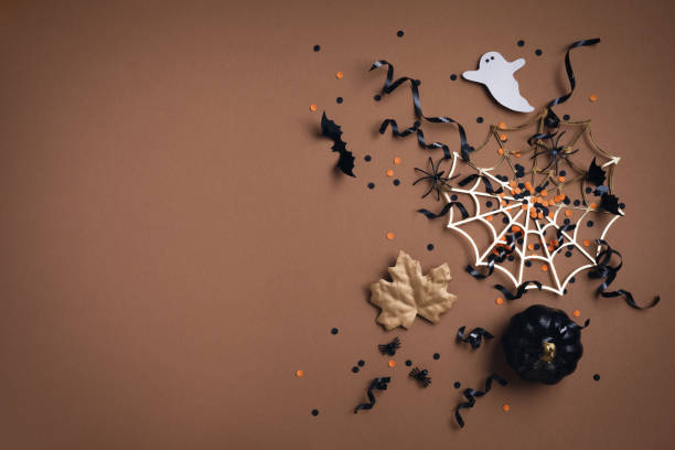 istock Halloween holiday background with party decorations from pumpkins, bats, spider web and ghosts top view. Happy halloween greeting card flat lay. 1691814614