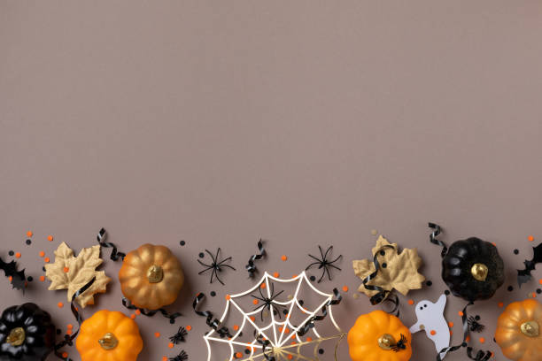 istock Halloween holiday background with party decorations from pumpkins, bats, spider web and ghosts top view. Happy halloween greeting card flat lay. 1691814635
