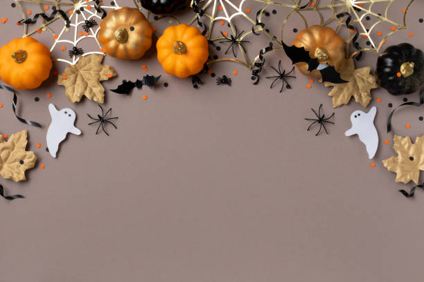 istock Halloween holiday background with party decorations from pumpkins, bats, spider web and ghosts top view. Happy halloween greeting card. 1691814808