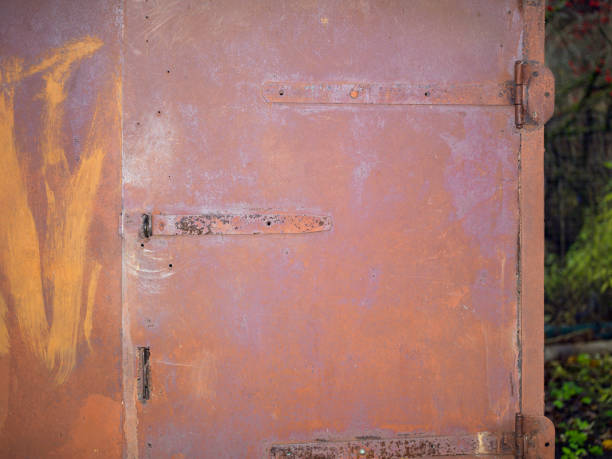 a metal rusty door of a warehouse or garage, outdoor cropped shot