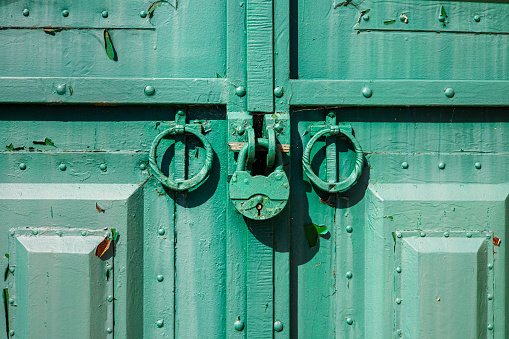 rusty padlock on an old closed door. old door with lock