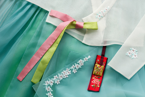 The colorful Hanbok, Korean traditional silk dress and ornaments for women. Holiday greeting concept with copy space. Top view.