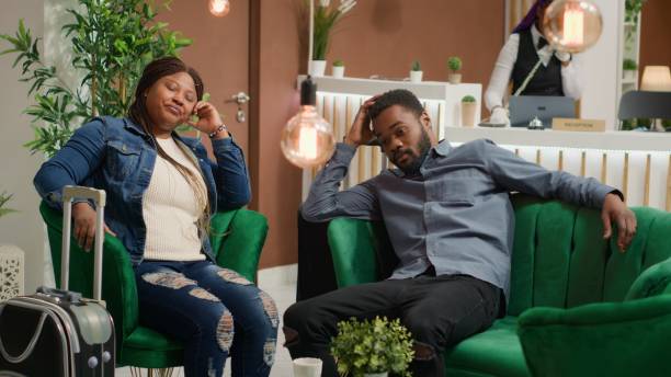 istock Exhausted couple resting in hotel lobby 1691852801