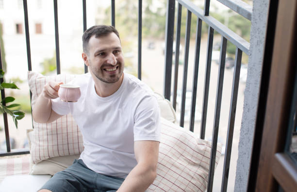 istock Man drinking coffee on the balcony. 1691879789