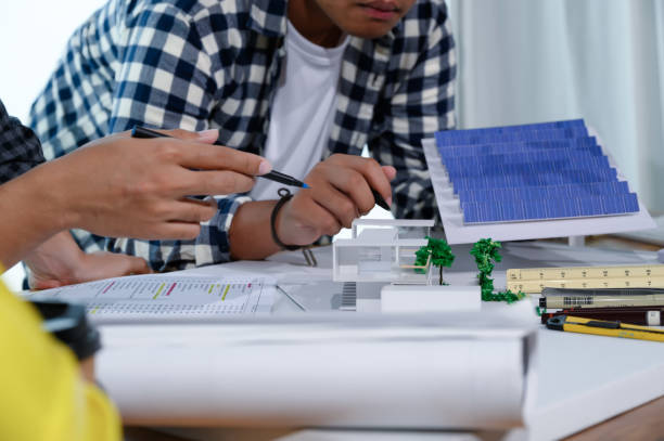 istock Asian Architect Students Studying Modern House Design and Finding Ways to Utilize Natural Alternative Energy or Use Natural Renewable Energy, Concepts of Eco-Friendly Living for a Sustainable Future. 1691882146