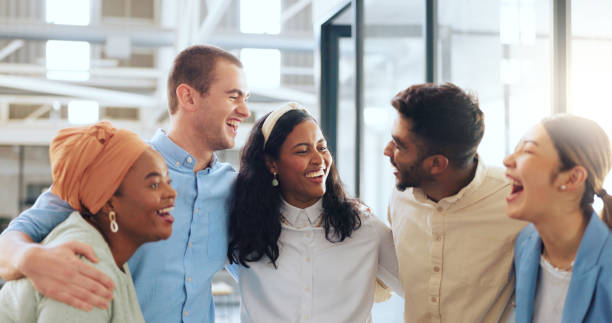 istock Office, diversity and business people hug for team building, teamwork and collaboration. Happy workers, smile and embrace in motivation, goals or vision of about us, company trust and startup growth 1691892802