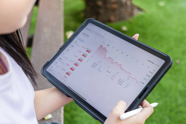 istock Woman looking at downturn stock chart on tablet. Red graph going down. Concept for fail and accidental business. falling economic and financial business crisis concept. Stock market concept. 1691899266