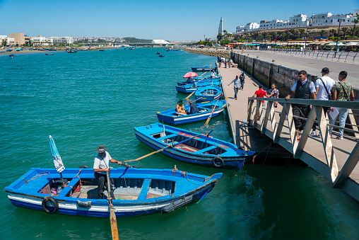 Rabat, Morocco - May 15, 2023: Tourists and boats on the Bou Regreg river in Rabat port. Morocco, Africa.