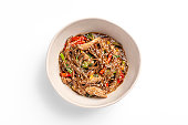 Stir fry noodles with vegetables and chicken in bowl