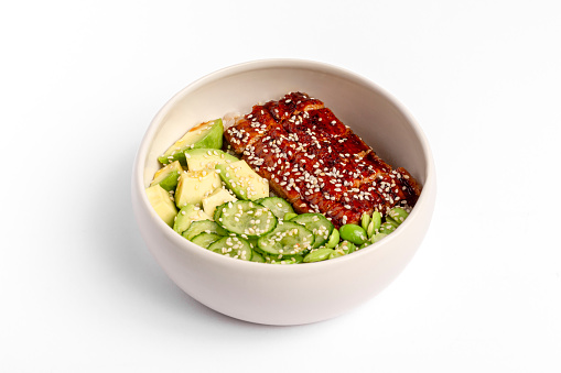 Green poke bowl with roasted chicken, cucumber, avocado and edamame beans. Top view. Close up.