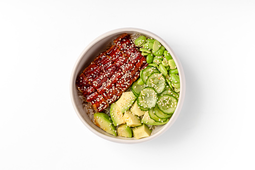Green poke bowl with roasted chicken, cucumber, avocado and edamame beans. Top view. Close up.