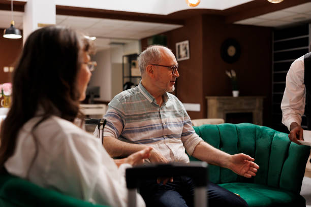 istock Elderly couple served by hotel employee 1691927146