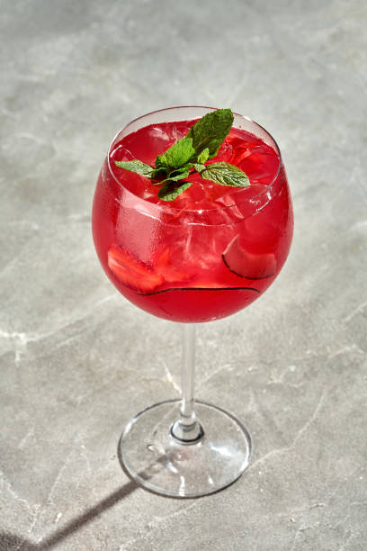 istock Rum-based alcoholic cocktail with strawberries and coconut in a glass on a dark background. Bar menu 1691928831