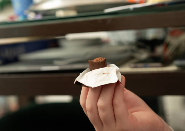 istock hand hold chocolate bar in daily life background ,close up 1691932774
