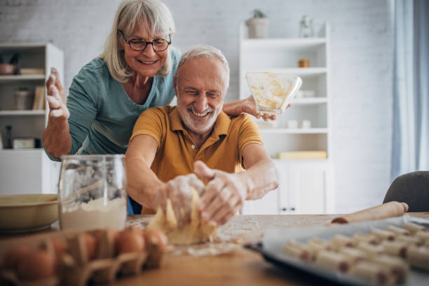 istock Happy couple preparing food together 1691935006