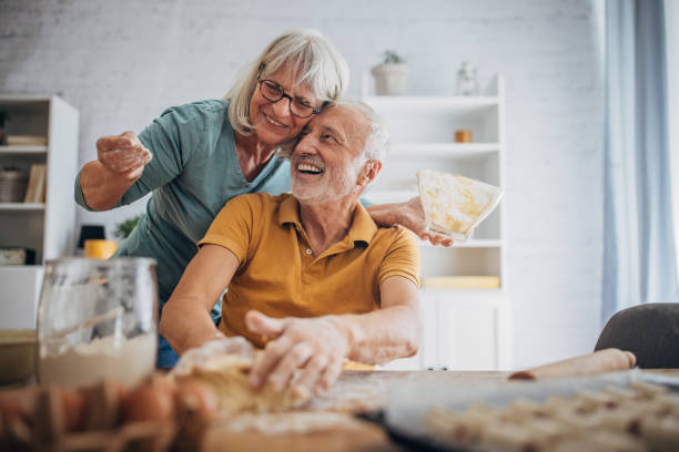 istock Happy couple preparing food together 1691936704