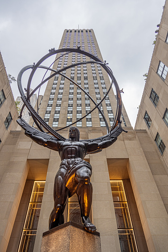 Fifth Avenue, Manhattan, New York, USA - August 8th 2023:  Low angle view of the Atlas Statue in front of the Rockefeller Center in midtown Manhattan