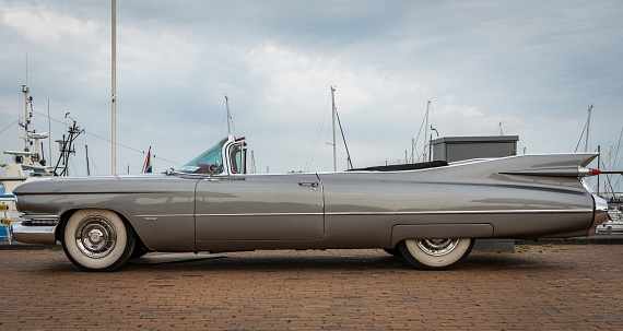 A side detail and interior of a brown stylish American classic car.