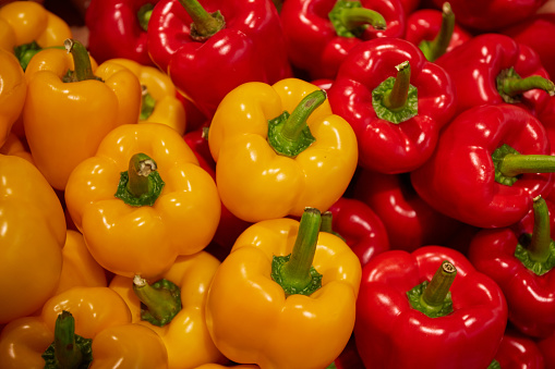 Red and yellow bell peppers in a market, Close-up of colorful bell peppers