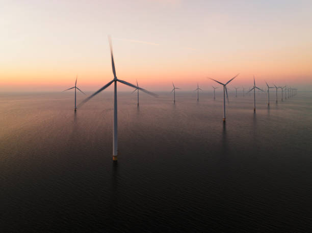 istock Wind turbines in an offshore wind park producing electricity during sunset 1691964362