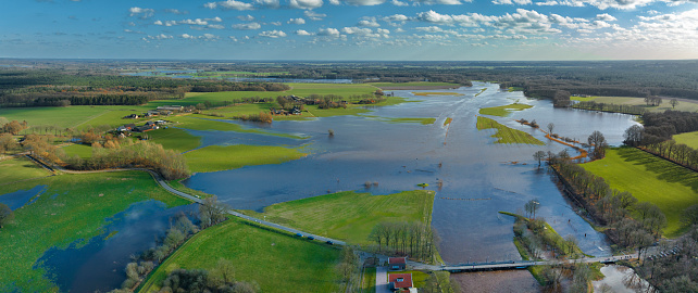 High water level in the river Vecht at the Junne weir in the Dutch Vechtdal region in Overijssel, The Netherlands. The river is overflowing on the floodplains after heavy rainfal upstream in The Netherlands and Germany during storm Eunice and Franklin in February 2022.