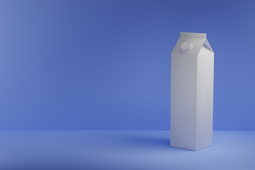 Front view of a blank milk container isolated on a blue background with copy space
