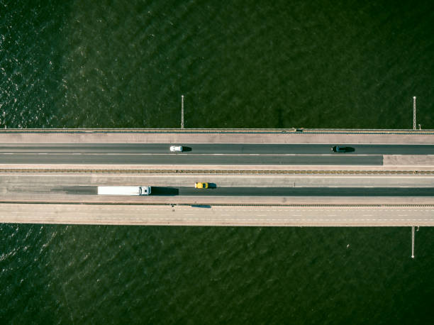 istock Traffic on a highway on a bridge overhead drone view 1691966132