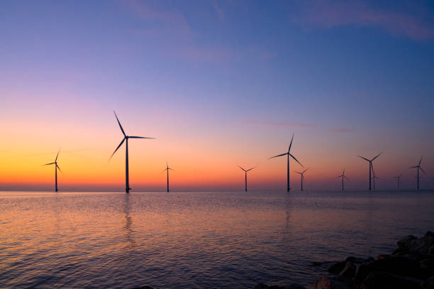 istock Wind turbines in an offshore wind park producing electricity during sunset 1691966754