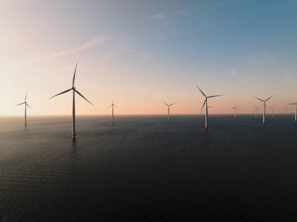 istock Wind turbines in an offshore wind park producing electricity during sunset 1691967338