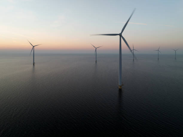istock Wind turbines in an offshore wind park producing electricity during sunset 1691969702