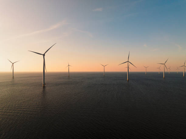 istock Wind turbines in an offshore wind park producing electricity during sunset 1691969855