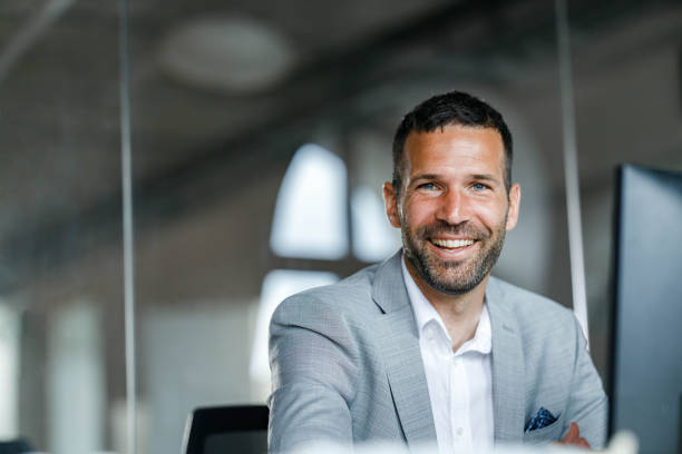 istock Happy businessman working on desktop PC at corporate office. 1691973726