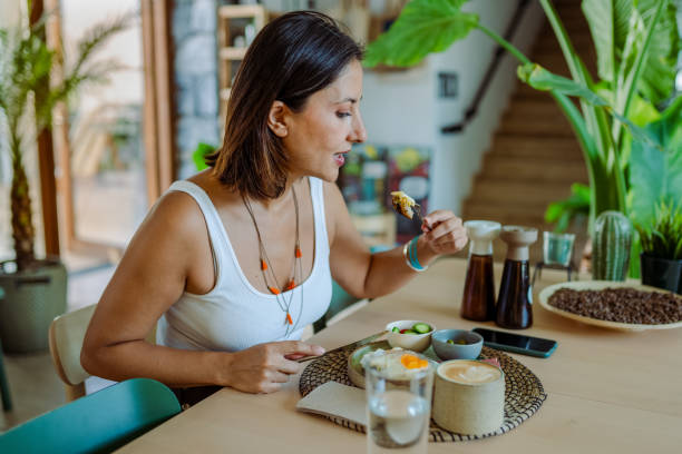 istock Woman having breakfast and feeling joy of being alone 1691976178
