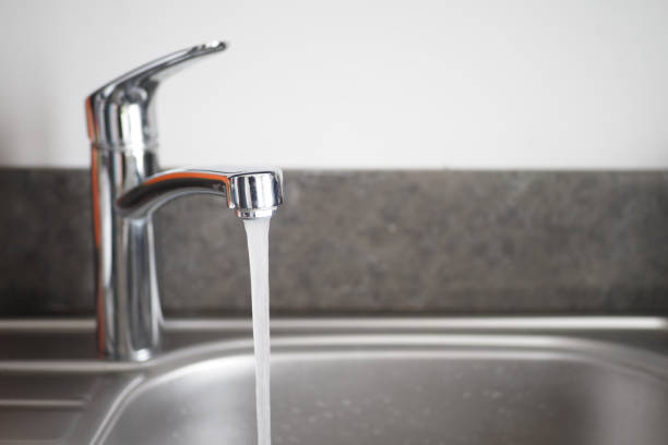 istock Water dripping from faucet tap at kitchen. Closeup 1691983476