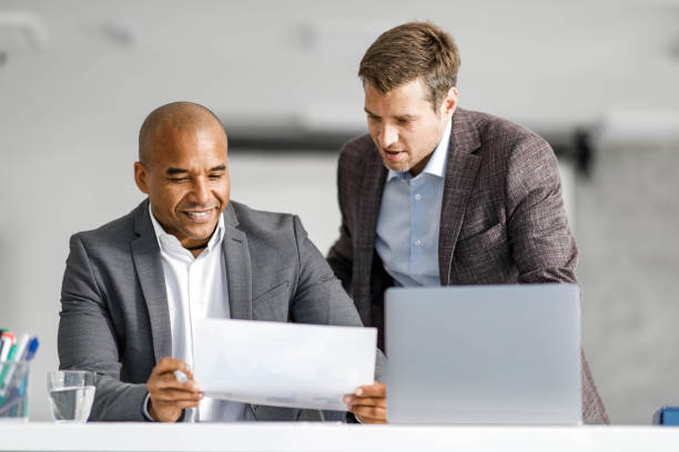 istock Male entrepreneurs analyzing business reports in the office. 1691988000