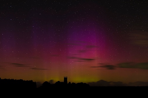 A Display of Aurora Borealis over a church in North Norfolk, UK