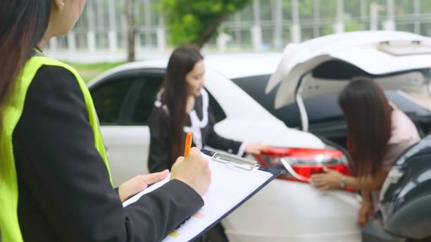 istock Insurance Agent Take notes and collect information After A Car Accident . 1691998693
