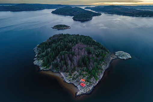 Aerial view of the twin islands of Garvik bay during a winter sunset - Sweden