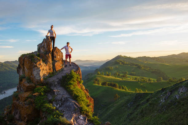 Happy man and woman on top mountain