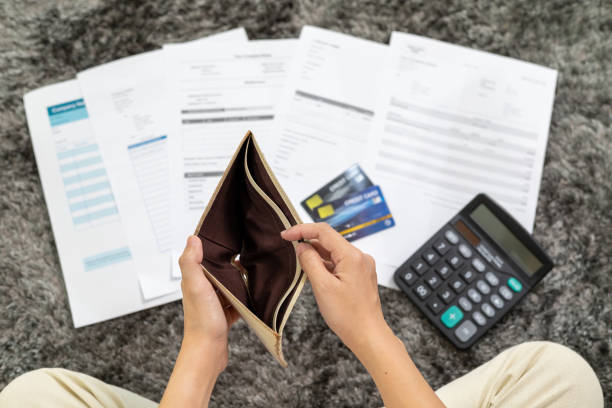 istock Young man unemployed Looks into his Empty Wallet are stressed about payment loan problem. A personal financial crisis concept. Debt, loan concept.Recession Situation and Hopelessness Crisis Concept. 1692005821